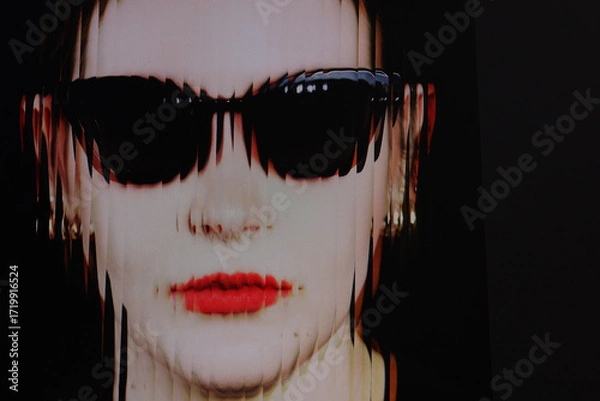 Fototapeta Closeup face of a woman with red lipstick and sunglasses with ripple glass effect