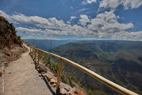 Fototapeta From the Mirador de Huancas, the Sonche Canyon reveals its breathtaking depth and immensity. Sheer cliffs plunge into the valley below, while the vast Andean landscape stretches beyond