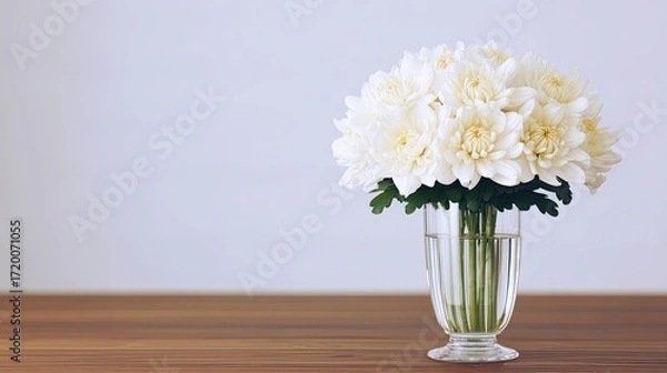 Fototapeta White Chrysanthemum Flowers in a Glass Vase Placed on a Wooden Table With a Plain Background