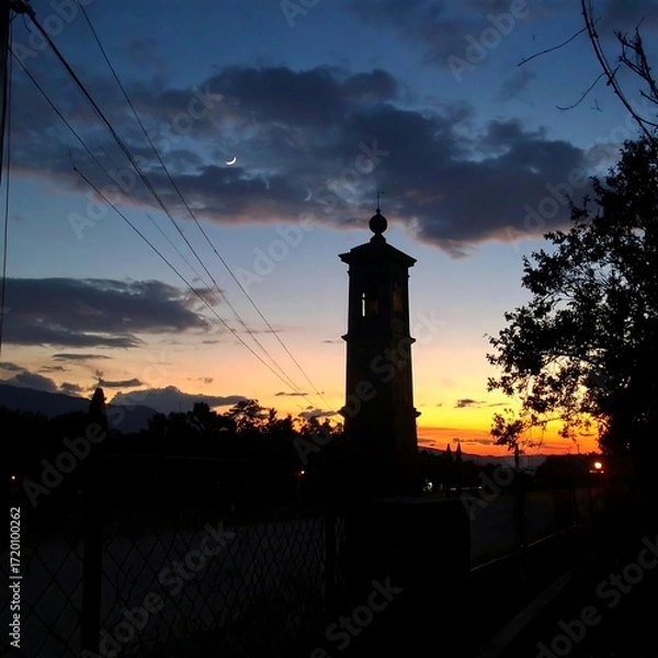 Fototapeta Silhouette tower at sunset
