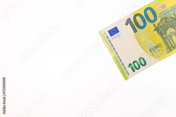Fototapeta Close-up of a 100 euro banknote on a white background, symbolizing finance, wealth, savings, currency, or economic value.