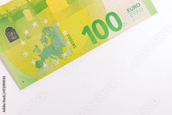 Fototapeta Close-up of a 100 euro banknote on a white background, symbolizing finance, wealth, savings, currency, or economic value.