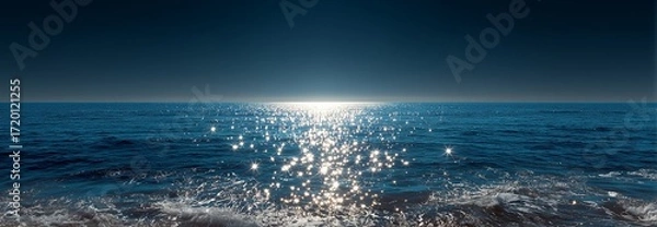Fototapeta Tranquil ocean view with sparkling water under a clear sky at twilight.