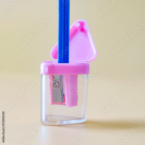 Fototapeta Pink pencil-sharpener on a over color background.