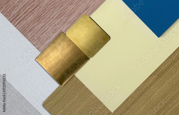 Fototapeta Interior design mood board. A mix of textures and materials, including natural wood veneer, brushed gold metallic, painted solid blue wood, cream laminated placed on wood and white fabric laminateds.