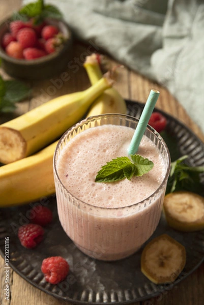 Fototapeta Refreshing banana raspberry smoothie with fresh mint for healthy living and summer enjoyment.
