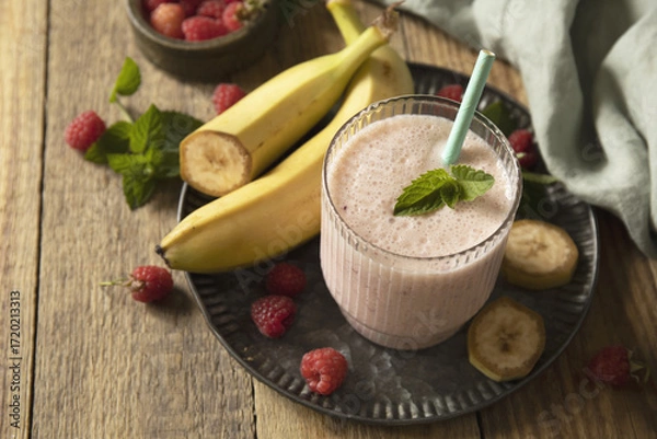 Fototapeta Refreshing banana raspberry smoothie with fresh mint for healthy living and summer enjoyment
