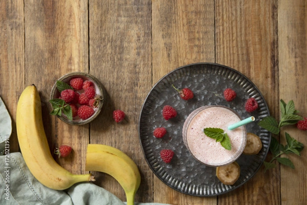 Fototapeta Refreshing banana raspberry smoothie with fresh mint for healthy living and summer enjoyment.