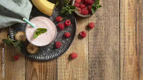 Fototapeta Refreshing banana raspberry smoothie with fresh mint for healthy living and summer enjoyment.
