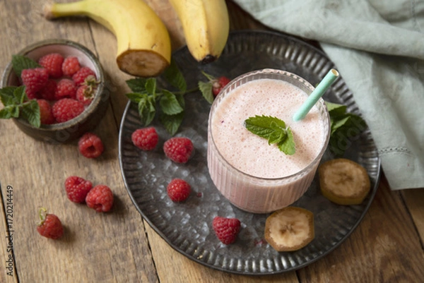 Fototapeta Refreshing banana raspberry smoothie with fresh mint for healthy living and summer enjoyment.