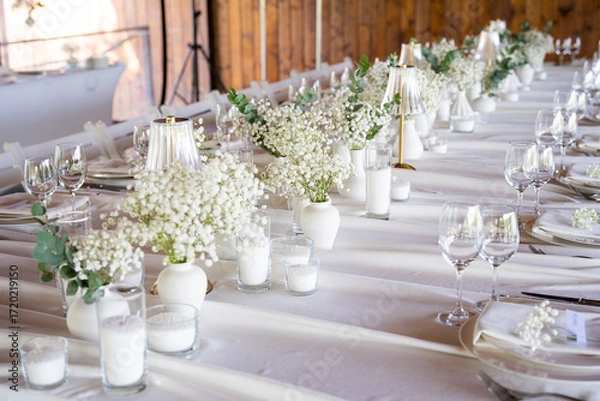Fototapeta beautiful table setting with flowers and cutlery on wooden table at wedding or dinner. stylish tablewear decorations	