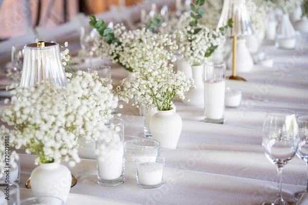 Fototapeta beautiful table setting with flowers and cutlery on wooden table at wedding or dinner. stylish tablewear decorations	