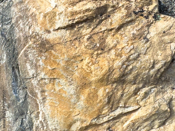Fototapeta Close-up of weathered rock surface with textured patterns