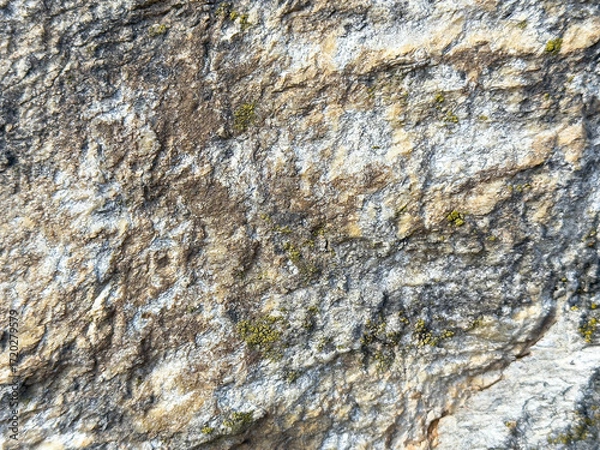 Fototapeta Rugged stone texture with natural weathering patterns