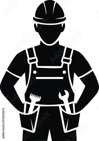 Fototapeta Silhouette of a construction worker wearing a hard hat and overalls holding tools