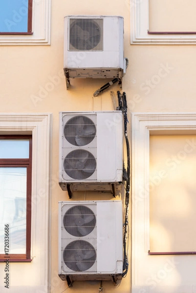 Fototapeta Air conditioners on the facade of the house, ventilation and cooling system, air purification technology. split system.