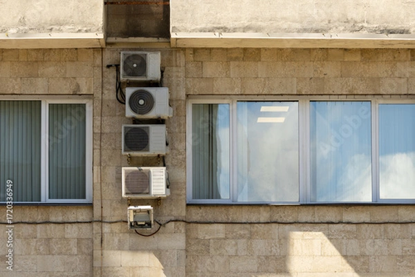Fototapeta Air conditioners on the facade of the house, ventilation and cooling system, air purification technology. split system.