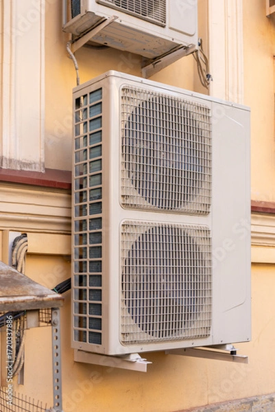 Fototapeta industrial C air conditioner is installed on the facade of a house or office. ventilation and cooling system, air purification technology. split system. cooling in hot weather. climate.