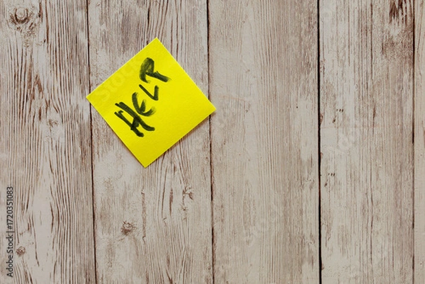 Fototapeta Yellow post-it note showing help message on wood background