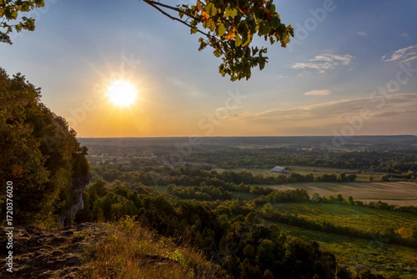 Obraz Beautiful sunset view from Mt. Nemo in Burlington, Ontario, showcasing a stunning landscape of fields, forests, and a radiant sky.