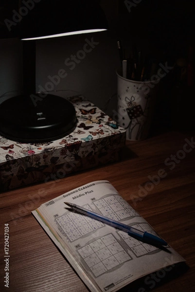 Fototapeta Close-up of Sudoku Under Desk Lamp