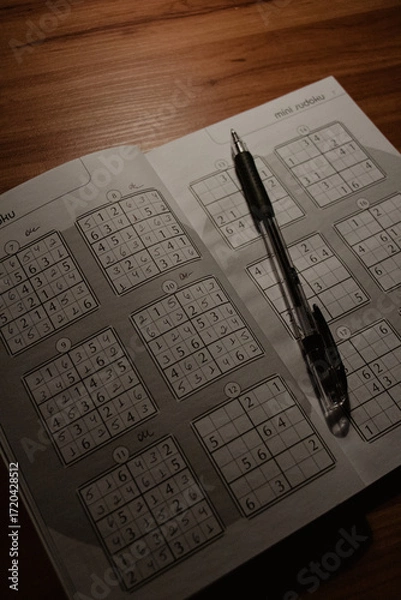 Fototapeta Sudoku Puzzle Book with Pen on Wooden Table