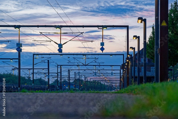 Fototapeta Rows of catenary gantries forming a dense station lattice in Padborg, Denmark