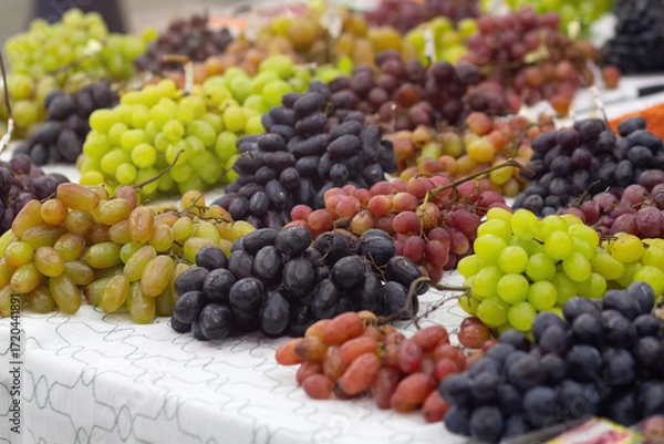 Fototapeta Various grape varieties on the market counter