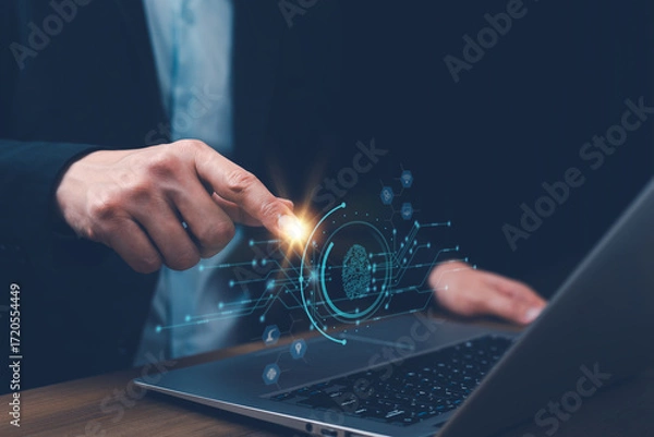 Fototapeta Businessman hand touch digital fingerprint scan on laptop, symbolizing cybersecurity, biometric authentication, identity verification, data protection, privacy, secure login, security technology.