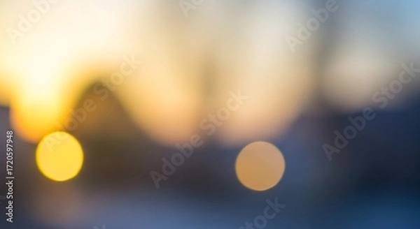 Fototapeta Soft-focus sunset scene shows blurred shapes and warm colors, creating a peaceful and tranquil ambiance.