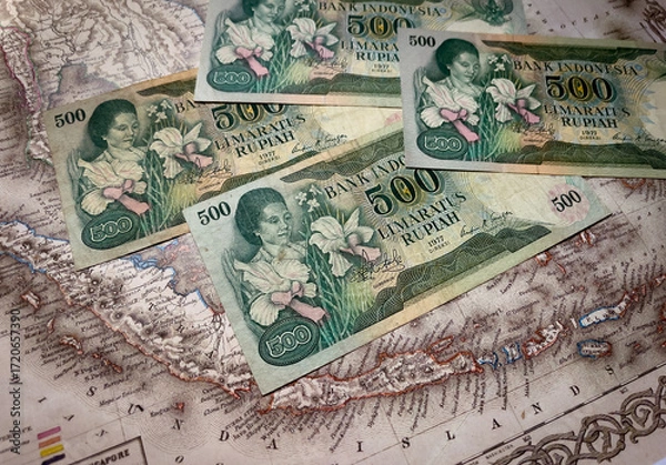 Fototapeta 500 rupiah 1977 five hundred indonesian rupiah banknotes from 1977 scatter across an indonesian map.