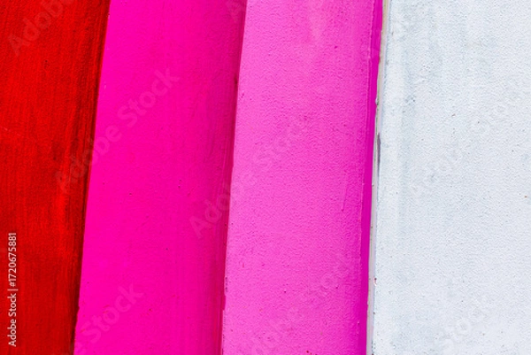Fototapeta Abstract colorful wall with red, pink, and white vertical stripes