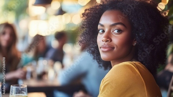 Fototapeta Young African-American woman curly hair sitting cafe restaurant Work Life Balance Initiatives