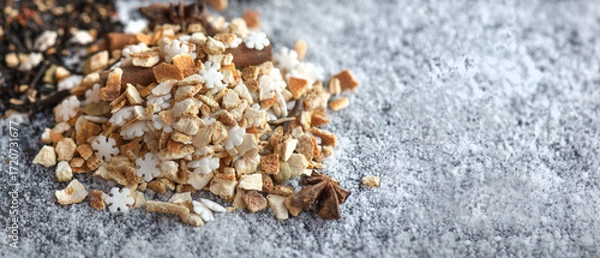 Fototapeta heap of sweet ingredients and spices for winter hot drink preparation on snowy background