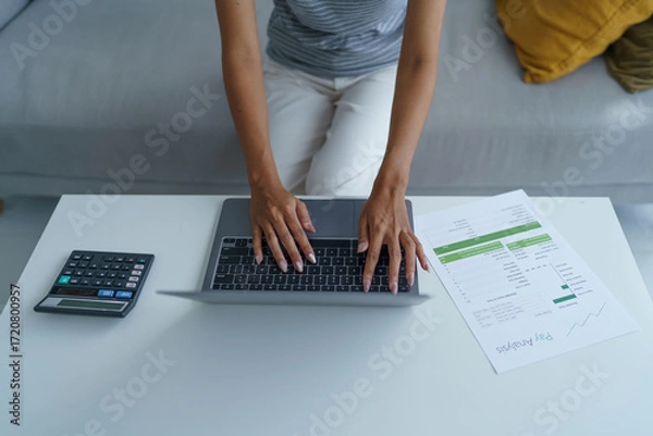 Fototapeta concentrated Asian woman using laptop computer creative girl working and typing on keyboard.