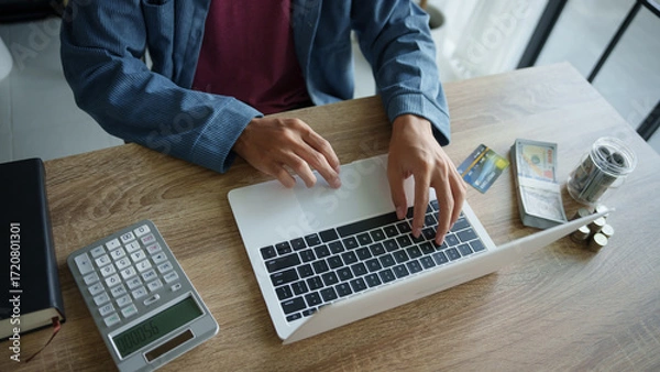 Fototapeta Business man saving money accountant financial analyst and auditor working and laptop for calculating