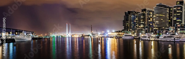 Fototapeta Panorama view of a beautiful view of docklands and The Bolte Bridge at night in Melbourne Australia..