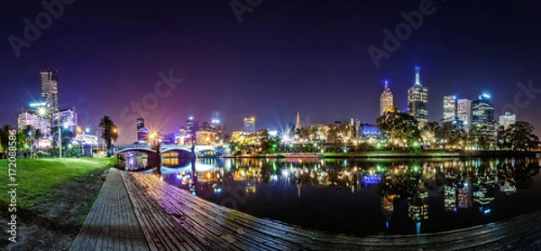 Fototapeta Panorama view of a beautiful view of docklands and The Princes Bridge with a cloudy sky and twilight in Melbourne Australia.
