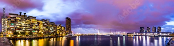 Fototapeta Panorama view of a beautiful view of docklands and The Bolte Bridge with a cloudy sky and twilight in Melbourne Australia.
