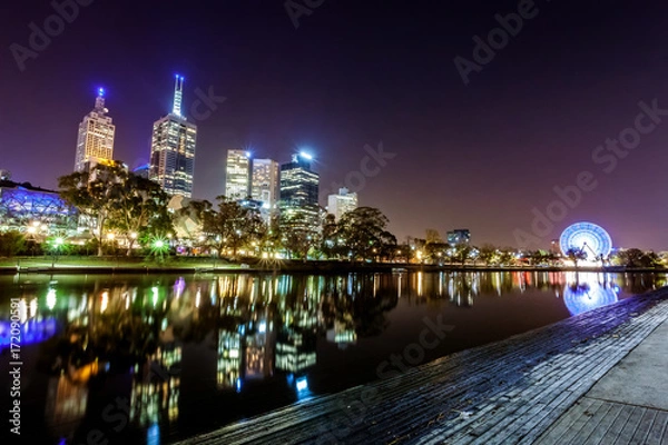 Fototapeta A view across the Yarra river atthe landmark of Melbourne downtown during the city’s nightime..