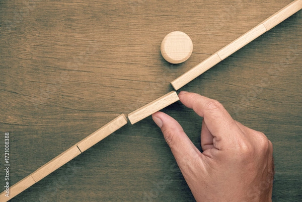 Obraz The last piece is placed as the round wooden object successfully crosses the gap, symbolizing successful execution, goal achievement, and progress through teamwork