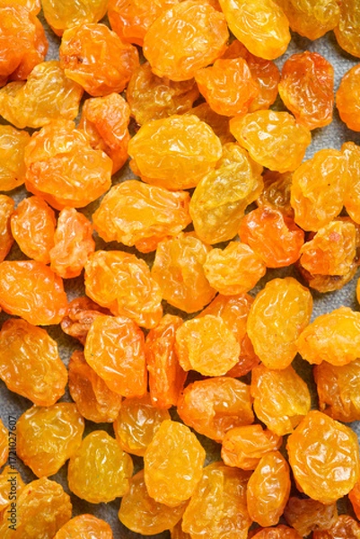 Fototapeta dried golden raisins, macro photo, on a stone background.
