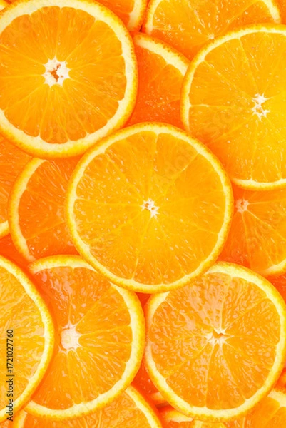 Fototapeta Slices of oranges close-up. Vertical photo. Top view.