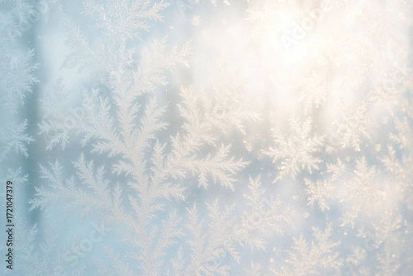 Fototapeta Delicate frost patterns on window with soft sunrise light creating a serene winter atmosphere