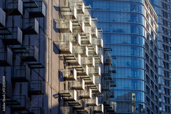 Obraz Glass balconies in multi-family buildings, apartment density, real estate, and housing market.