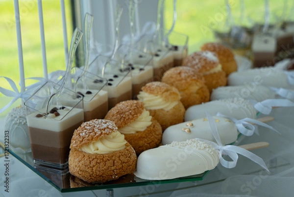 Fototapeta Candy bar with  with macaroons, different sweets and cupcakes. Wedding buffet.