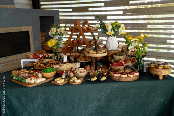 Fototapeta Catering buffet with variety of food snacks and appetizers.