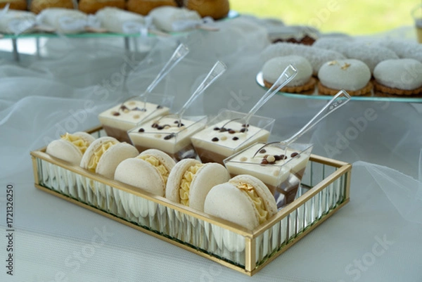 Fototapeta Candy bar with  with macaroons, different sweets and cupcakes. Wedding buffet.
