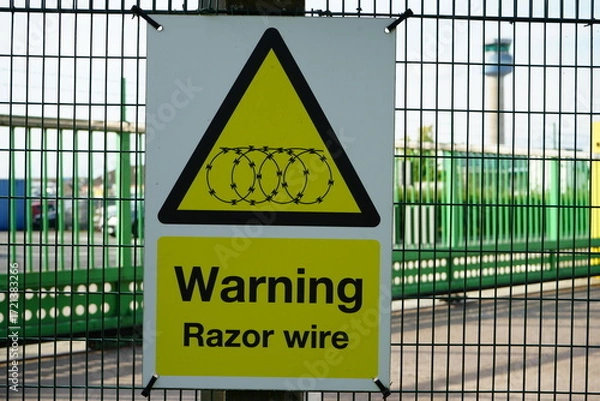 Obraz Warning Sign for Razor Wire at East Midlands Airport Trail, Nottinghamshire, England