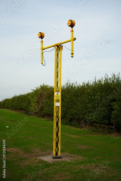 Obraz High Voltage Warning Sign on a Yellow Pylon: East Midlands Airport Trail, Nottinghamshire, England
